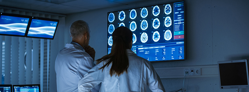 two providers looking at a brain scan