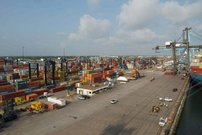 Warehouse space in Houston with freight trucks, pallets, and dock doors-representing 3PL services, cross-docking, and short-term storage solutions in a Houston logistics hub.