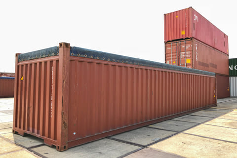 Open-top intermodal containers (above) allow oversized cargo like machinery to be loaded from the top. A removable tarp covers the roof opening to protect goods from weather.