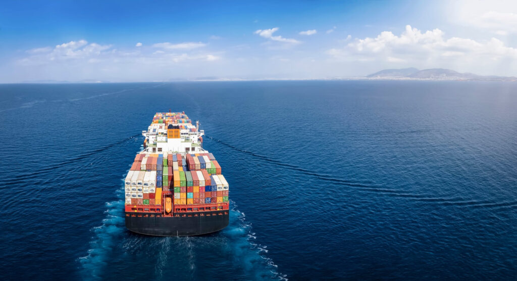  Large cargo ship transporting colorful intermodal freight containers across the ocean, demonstrating global intermodal shipping logistics.
