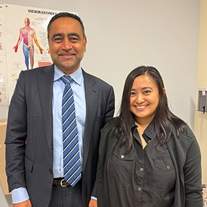 A doctor and patient smiling in a medical room