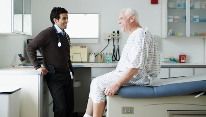 male provider with senior patient in exam room