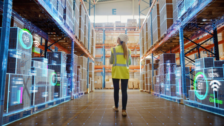 Worker in a smart warehouse with digital inventory systems and analytics, representing the future of retail logistics.