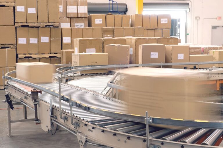 Warehouse staff picking and packing eCommerce orders in a modern fulfillment center to prepare for shipping and delivery.