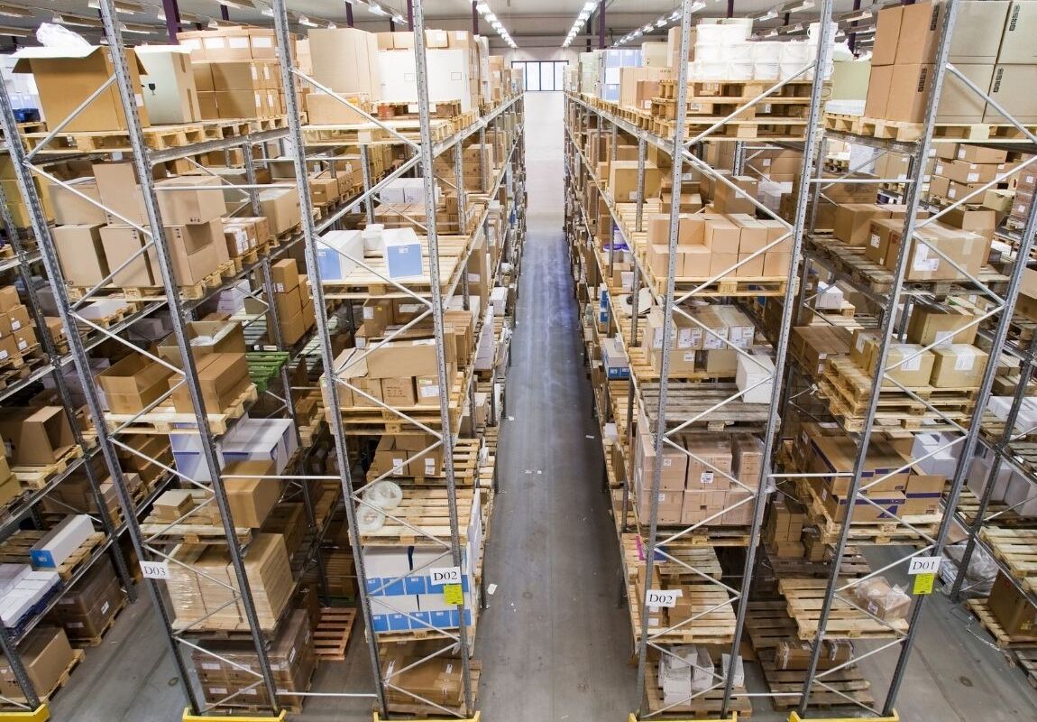 Warehouse worker scanning inventory for backorder management