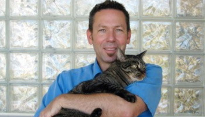 Alan Caviness holding a cat. 