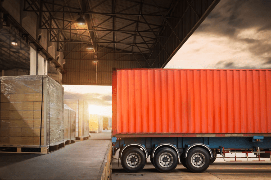 Forklift loading goods during container transloading at a Miami warehouse facility.