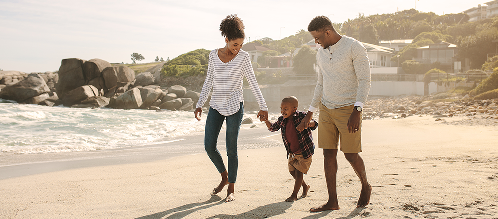 family walking along beach